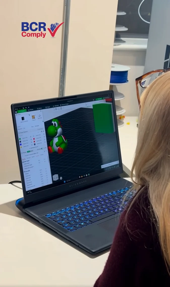 A laptop showing a colourful 3D model in design software